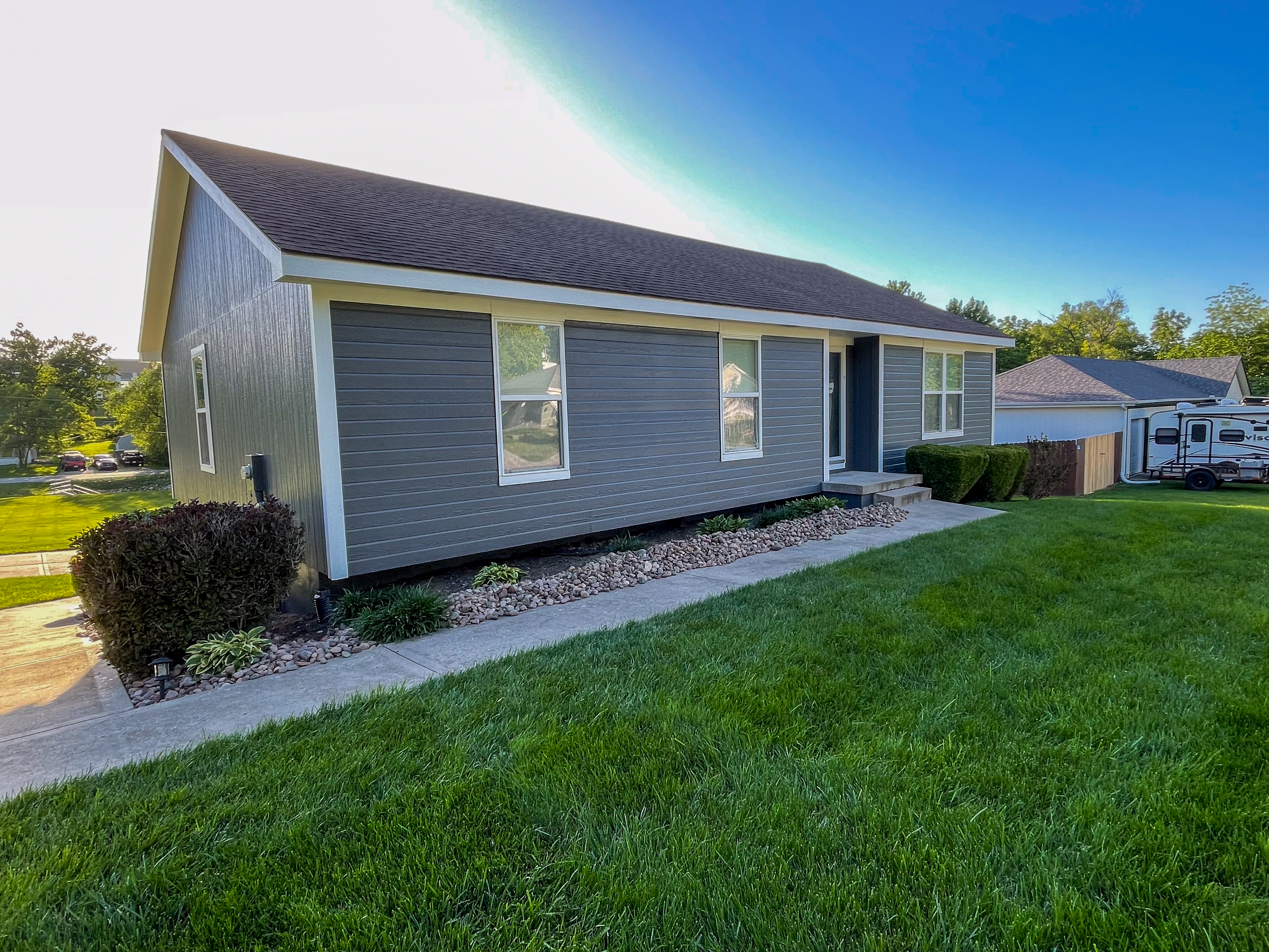 Freshly painted ranch-style house exterior in Belton, MO by Red Letter Painting